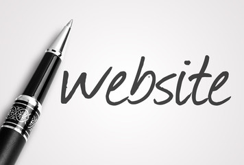 Fototapeta premium pen writes website on paper