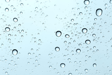 Water drop on glass mirror background.