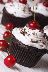 delicious chocolate cupcakes with cherry close up, vertical
