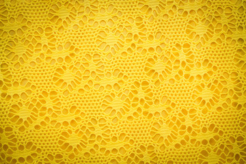 Yellow lace fabric background texture.