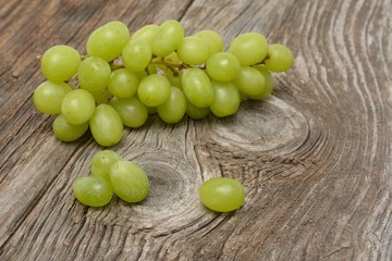 green grapes on wooden background