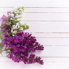 Lilac flowers on wooden background.