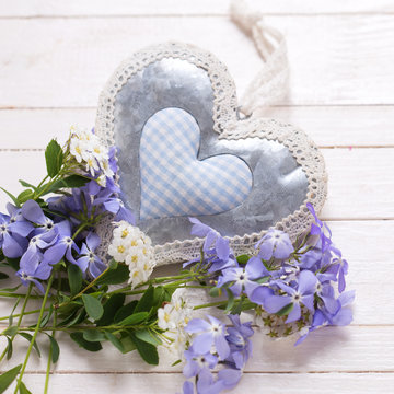 Background with  blue  flowers and  decorative heart