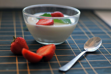 Vegetarian breakfast with yogurt, strawberry, honeysuckle and mint