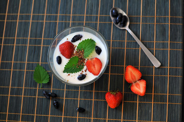 Vegetarian breakfast with yogurt, strawberry, honeysuckle and mint