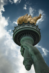 The torch of the Statue of Liberty on a cloudy day © Victor Moussa