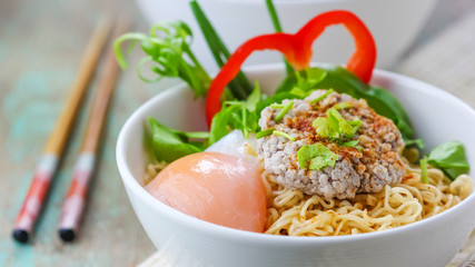 Chinese noodles with minced pork and egg in bowl