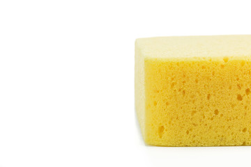 Yellow Sponge Close-up with space on white background
