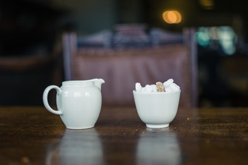 Milk and sugar on table in dining room