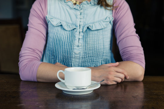 Woman having tea or coffee
