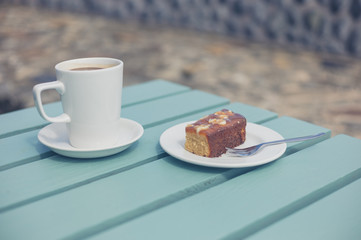Coffee and cake on table outside