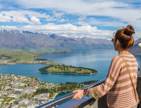 Young adult woman enjoy a stunning view of Queenstown