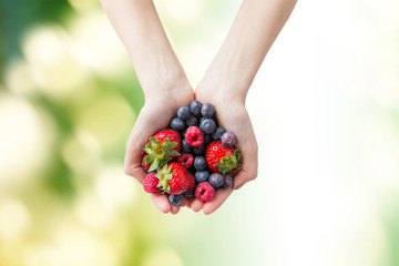 close up of woman hands holding berries