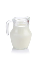 Glass jug of fresh milk isolated on white