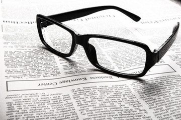 Glasses on newspaper