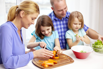 happy family with two kids cooking at home