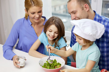 happy family with two kids cooking at home