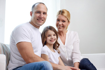 happy parents with little daughter at home
