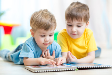 Cute boys at home reading