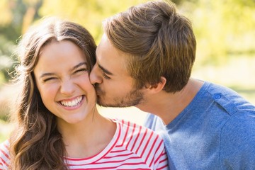 Cute couple kissing in the park