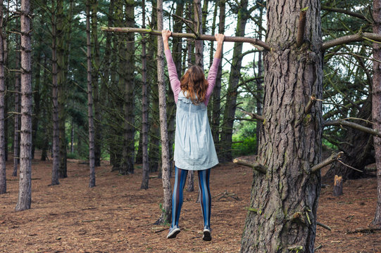 Young woman climbing a tree