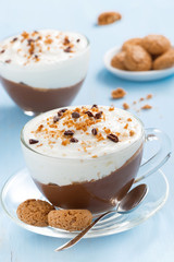dessert with chocolate, cream and amaretti on a blue table