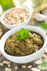 pesto sauce in a bowl, top view, close-up
