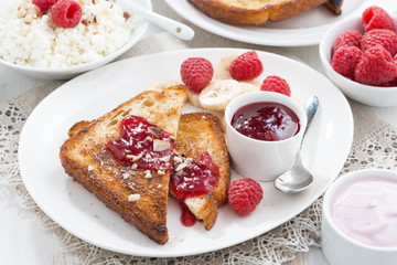 sweet breakfast - crispy toasts with raspberries, banana and jam