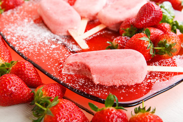 Homemade ice cream pops with fresh berries.