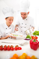 Young attractives professionals chefs cooking together