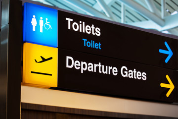 Airport sign for toilet and departure gates 