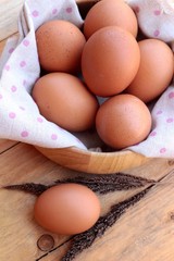 Chicken brown eggs on wood background