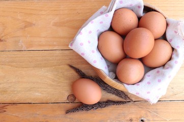 Chicken brown eggs on wood background