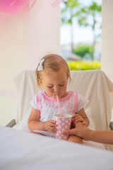 Fototapeta premium Mother Gives Her Daughter Drink