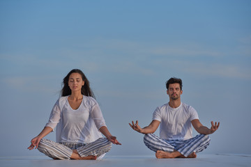 young couple practicing yoga