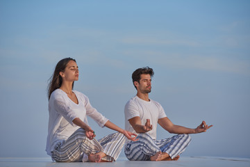 young couple practicing yoga