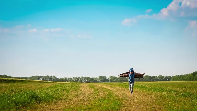 Happy kid playing in summer field