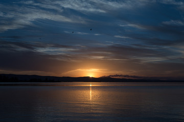 Fototapeta na wymiar sunset at coast of the lake