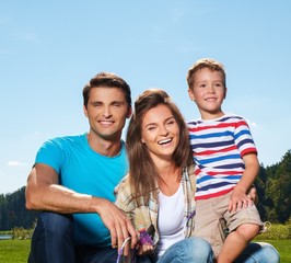 Happy young family with their child outdoors