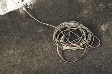 electric extension cord plug  at construction site - obrazy, fototapety, plakaty