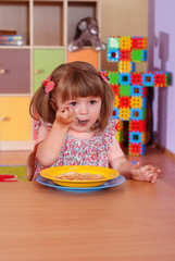 Two-year girl playing and learning in preschool