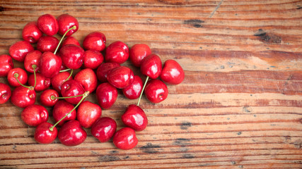Ripe organic homegrown cherries on wooden background