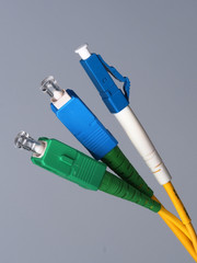Three single fibre optic connectors used for indoor fiber optic network installation in Melbourne,...