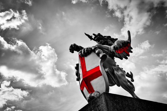 Fototapeta St George dragon statue in London, the UK. Black and white, red flag, shield.