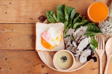 soft-boiled egg on toast with sliced pork tenderloin.