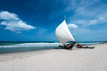 Afwasbaar Fotobehang Kust Beautiful canves boat in the beach in hot sunny day