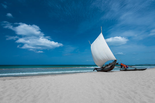Fototapeta Beautiful canves boat in the beach in hot sunny day