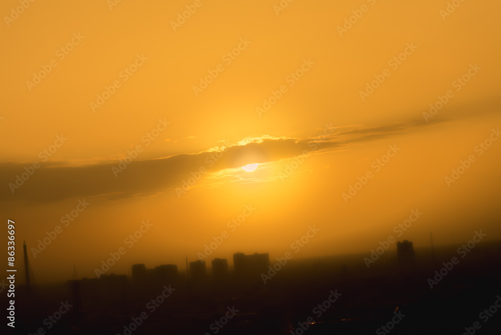 Wall mural Orange sunset sky in urban with  mist