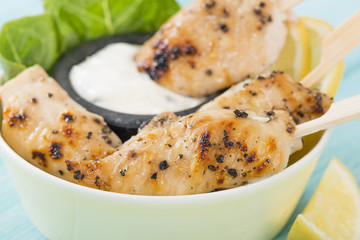 Chicken Satay - Char-grilled spicy mini chicken fillet skewers served with lemon and aioli dip.
