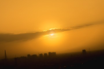 Orange sunset sky in urban with  mist